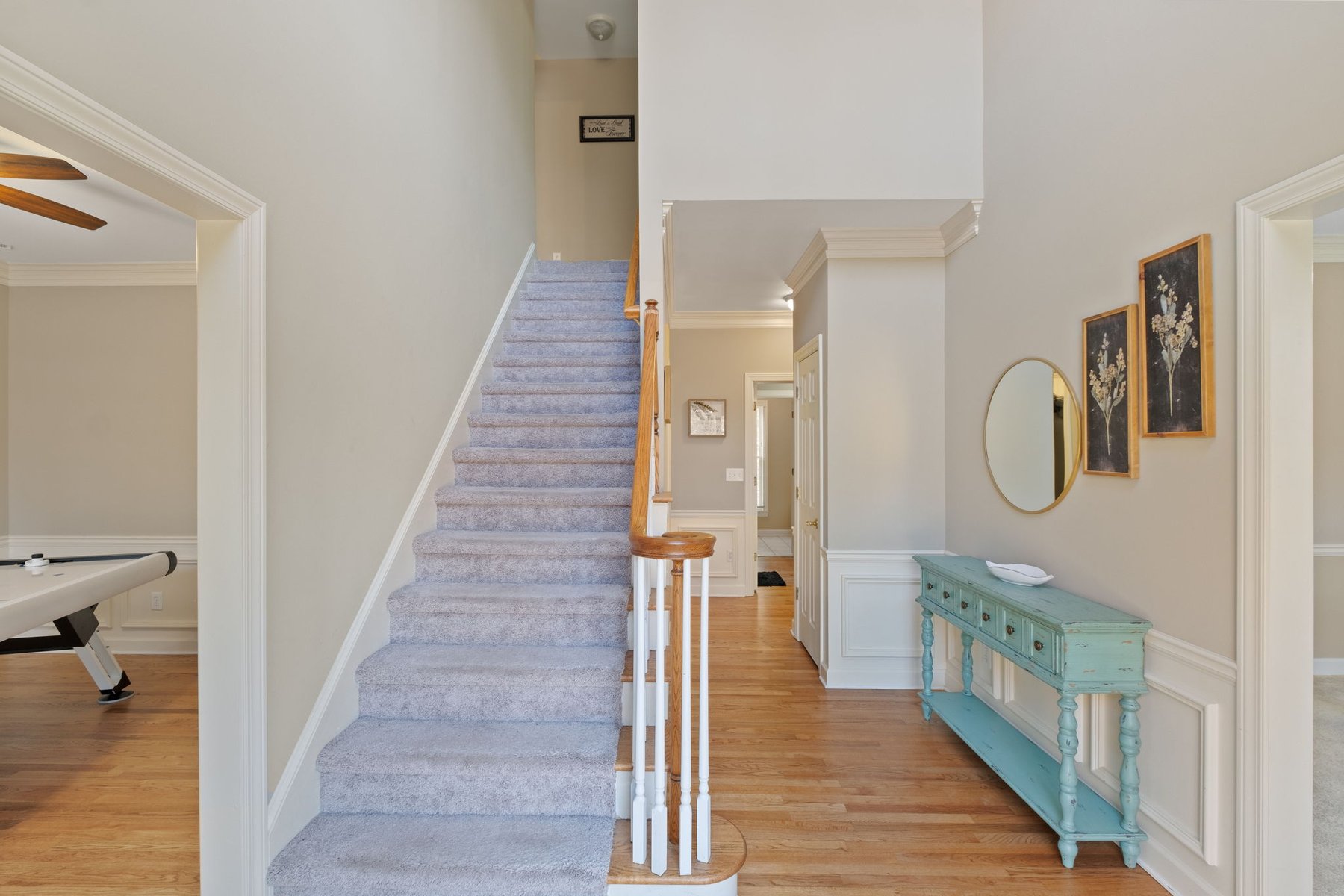 Entry foyer with console table and staircase