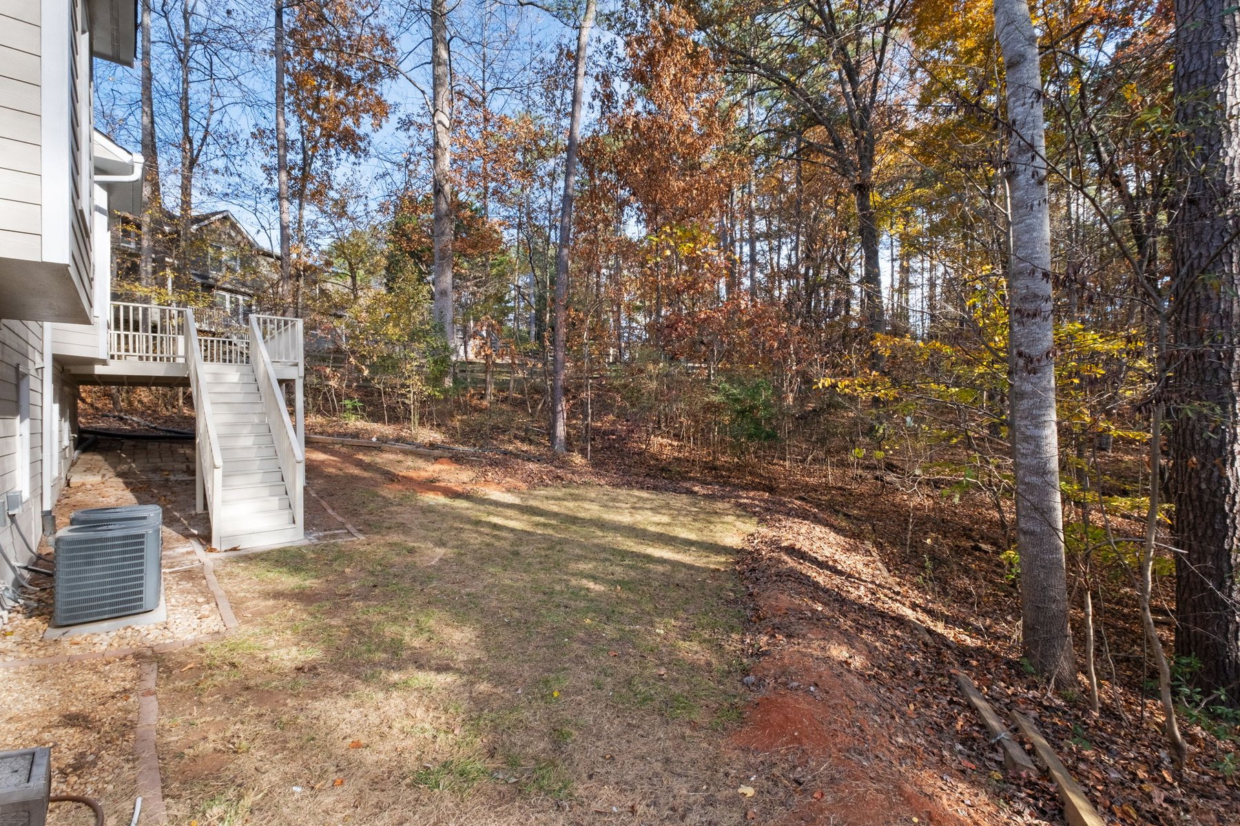 Wooded backyard and lawn behind the home