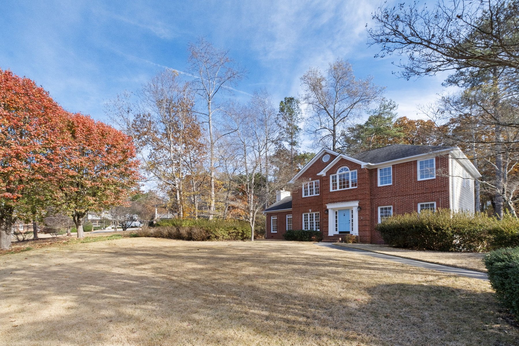 Front exterior of the home framed by trees