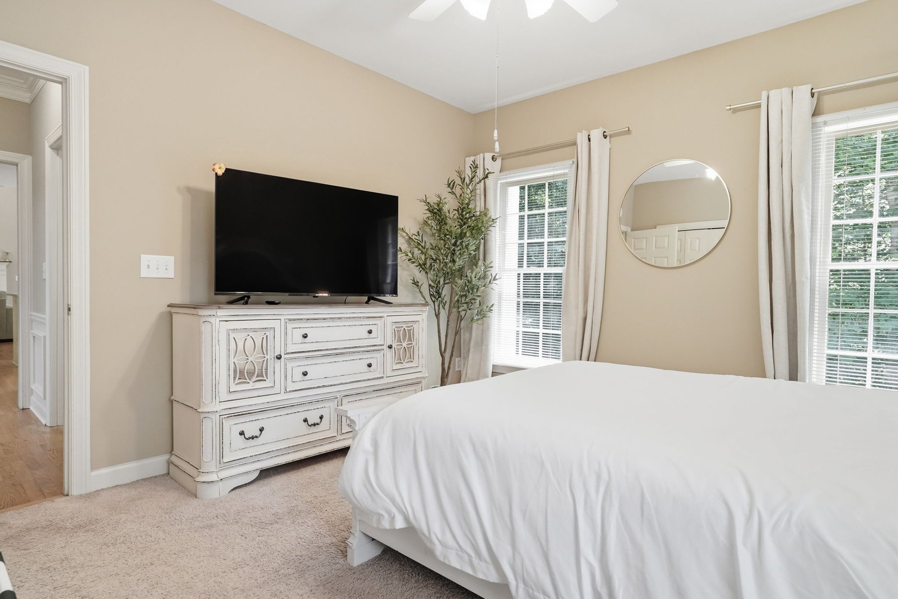 Bedroom with bed and seating area near the windows