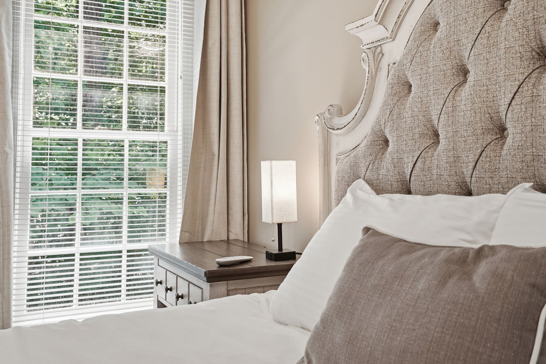 Bedroom with television, dresser, and mirror