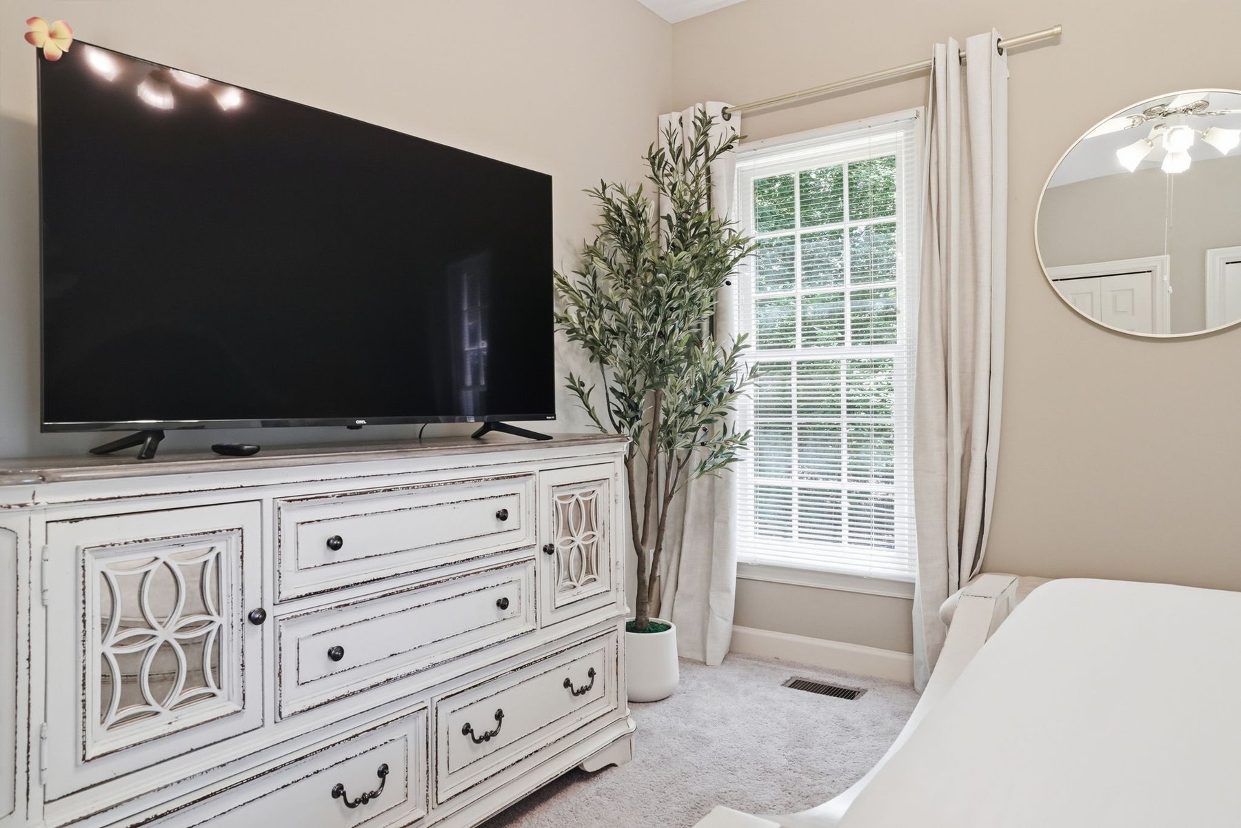 Bedroom with a bed, window, and bedside table