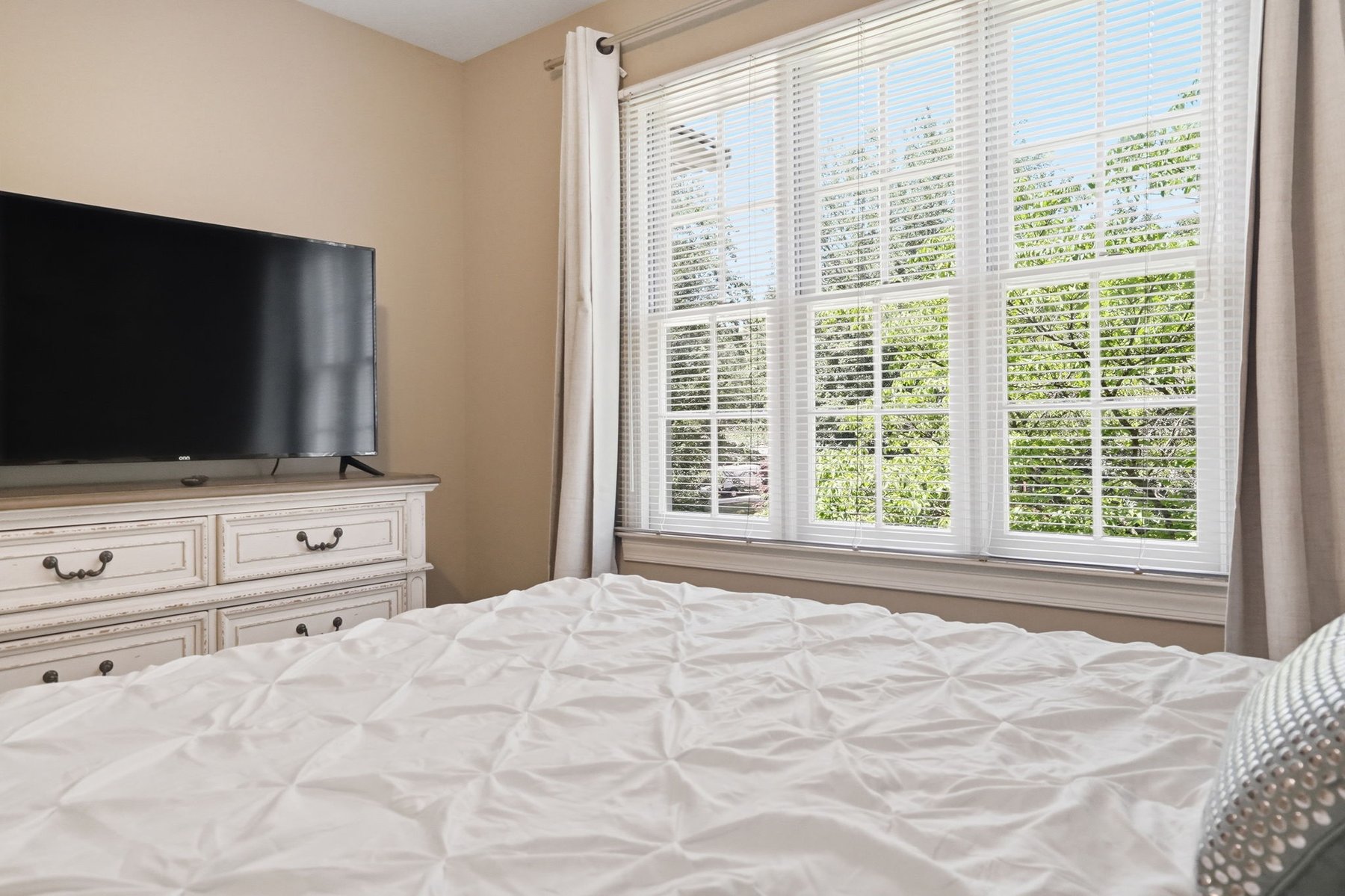 Bedroom with television and window