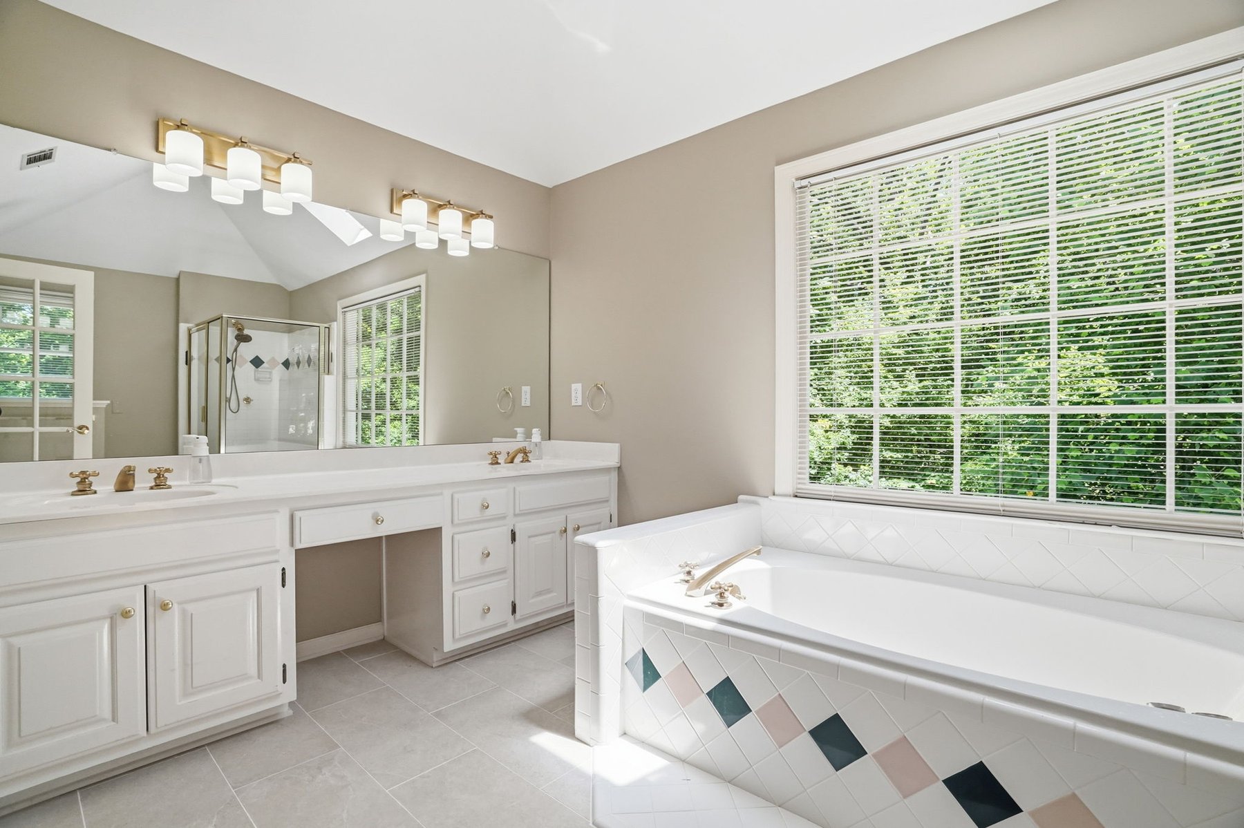 Bathroom with soaking tub and vanity